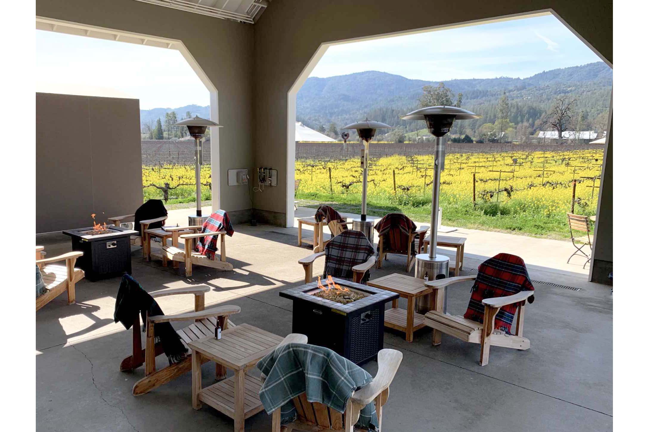Our crush pad set up for outdoor tastings with adirondack chairs and Pendleton blankets around fire pits