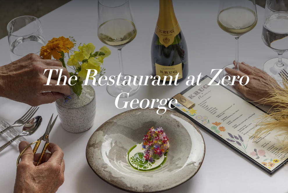 "The Restaurant at Zero George" with a photo of food, wine, a menu and flowers.