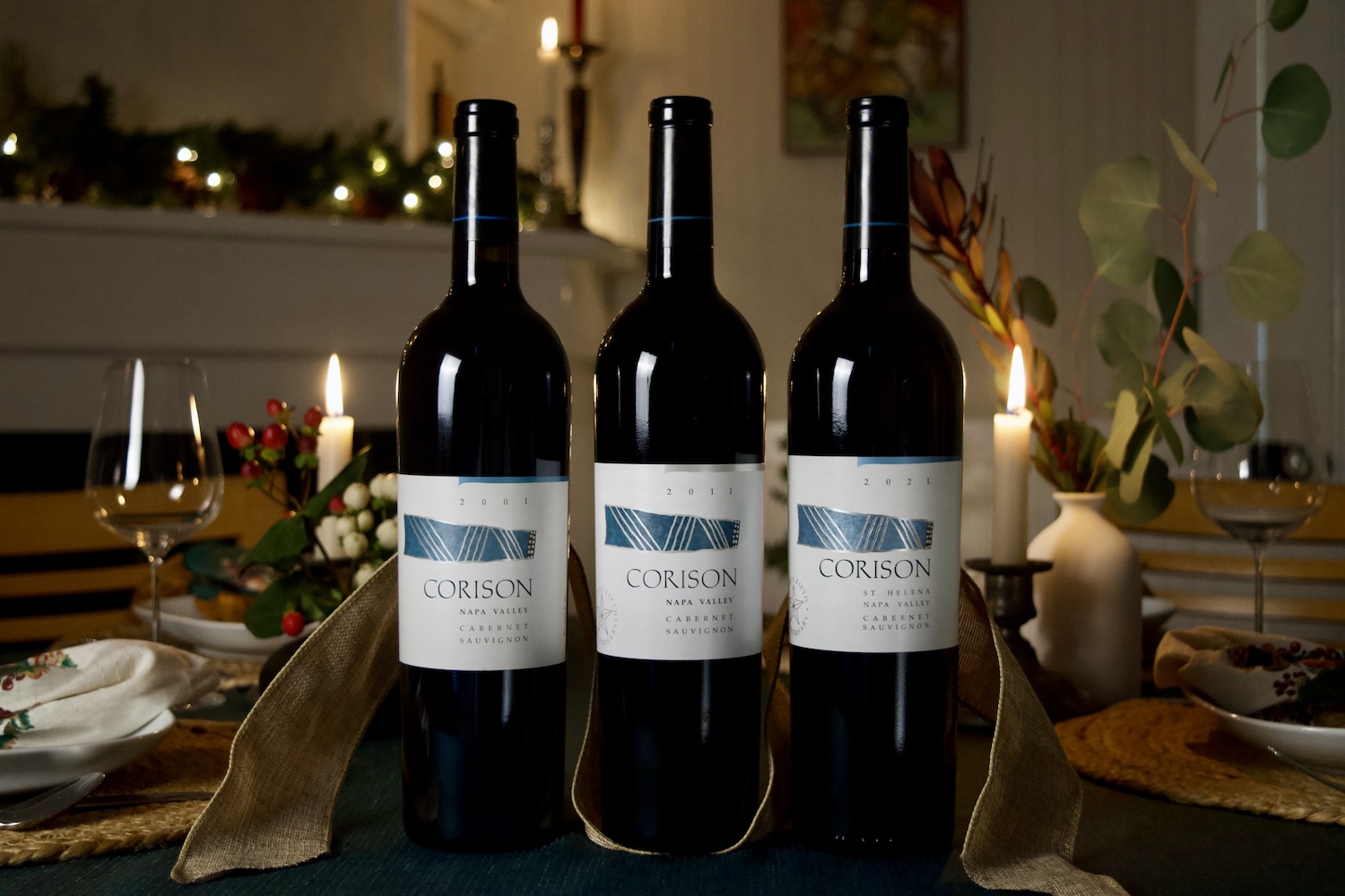 2001, 2011 and 2021 Corison Napa Valley Cabernet Sauvignon on a holiday table.