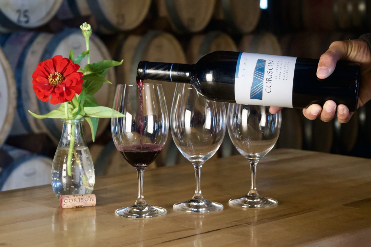 A bottle of the 2023 Corison St. Helena Napa Valley Cabernet Sauvignon being poured into a glass in the Corison barrel room.